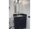 Bathroom vanity with black cabinets, black countertop, rectangular mirror, and silver faucet at 963 Yorktown Dr, Charleston, SC 29412