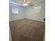 Bedroom with neutral carpet, ceiling fan with light and two windows with blinds at 963 Yorktown Dr, Charleston, SC 29412