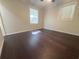 An empty bedroom with newly refinished dark hardwood flooring and freshly painted walls at 963 Yorktown Dr, Charleston, SC 29412