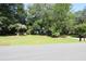Charming home exterior with lush landscaping, mature trees and a long driveway at 963 Yorktown Dr, Charleston, SC 29412