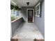 Exterior front porch with front door, hanging plants, and large windows at 963 Yorktown Dr, Charleston, SC 29412