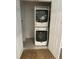 Compact laundry closet features a stacked washer and dryer unit for space-saving convenience at 963 Yorktown Dr, Charleston, SC 29412