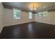Spacious living room with dark hardwood floors, paneled walls, and plenty of natural light at 963 Yorktown Dr, Charleston, SC 29412