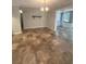 Open living room featuring travertine tile flooring, neutral walls, and modern lighting at 963 Yorktown Dr, Charleston, SC 29412