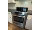 Stainless steel oven with glass cooktop, set against white cabinets and subway tile backsplash at 963 Yorktown Dr, Charleston, SC 29412