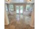 Cozy sun room features neutral tiling, tongue-and-groove ceiling, and access to the backyard through double doors at 963 Yorktown Dr, Charleston, SC 29412