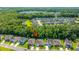 Aerial view of a residential community surrounded by trees and a pond at 9710 Table Mountain Ln, Ladson, SC 29456
