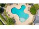 A community pool is surrounded by lounge chairs, greenery, and sidewalks perfect for a relaxing afternoon at 9710 Table Mountain Ln, Ladson, SC 29456