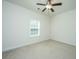 Cozy bedroom featuring neutral carpeting, a ceiling fan, and a bright window at 9710 Table Mountain Ln, Ladson, SC 29456