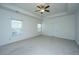 Primary bedroom with tray ceiling, carpet, and ample natural light at 9710 Table Mountain Ln, Ladson, SC 29456