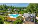 A community pool is shown with a clubhouse, a pergola, lounge chairs, a playground and neighborhood homes nearby at 9710 Table Mountain Ln, Ladson, SC 29456