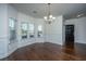 Bright dining room with hardwood floors, wainscoting, bay windows, and decorative chandelier at 9710 Table Mountain Ln, Ladson, SC 29456