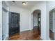 Welcoming foyer featuring dark hardwood floors, arched doorway, and a black front door at 9710 Table Mountain Ln, Ladson, SC 29456