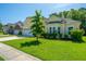Inviting home exterior with lush green lawn, mature landscaping, and a well-maintained facade at 9710 Table Mountain Ln, Ladson, SC 29456