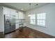Well-appointed kitchen featuring white cabinetry, stainless steel refrigerator, and built-in desk area at 9710 Table Mountain Ln, Ladson, SC 29456