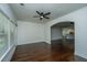 Living room featuring hardwood floors, a ceiling fan, and an arched entryway at 9710 Table Mountain Ln, Ladson, SC 29456