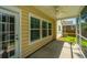 Covered and screened-in back porch with outdoor fan at 9710 Table Mountain Ln, Ladson, SC 29456