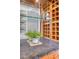 Close-up of bar with mirrored backsplash, wooden wine rack, and sleek countertop at 1 King St # 209 & 210, Charleston, SC 29401