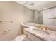 Bathroom featuring marble countertop, gold fixtures and a large mirror at 1 King St # 209 & 210, Charleston, SC 29401