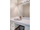 Bathroom vanity with silver tray, towels, decor, and lit mirror in view at 1 King St # 209 & 210, Charleston, SC 29401