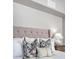 Detailed view of bedroom headboard, decorative pillows, and lamp with bedside table at 1 King St # 209 & 210, Charleston, SC 29401