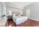 Spacious bedroom featuring hardwood floors, neutral walls, and a comfortable bed with decorative pillows at 1 King St # 209 & 210, Charleston, SC 29401