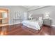 Cozy bedroom with hardwood floors, light gray walls, and an ensuite bathroom at 1 King St # 209 & 210, Charleston, SC 29401