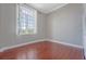 Empty bedroom with hardwood floors, window with shutters, and neutral wall paint at 1 King St # 209 & 210, Charleston, SC 29401