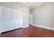 Bedroom with dark wood flooring, closet with bi-fold doors, and grey walls at 1 King St # 209 & 210, Charleston, SC 29401