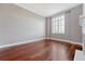 Bedroom with hardwood floors, neutral paint, and natural light from a window at 1 King St # 209 & 210, Charleston, SC 29401