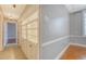 Hallway with built-in display shelving, carpet and tile flooring, and soft lighting at 1 King St # 209 & 210, Charleston, SC 29401