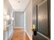 Hallway with parquet wood floor illuminated with a glass table and lamps at 1 King St # 209 & 210, Charleston, SC 29401