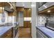 Kitchen with stainless steel appliances, blue counters, and wood cabinets at 1 King St # 209 & 210, Charleston, SC 29401