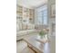 Inviting living room featuring a comfortable couch, bright window, built-in shelves, and stylish decor at 1 King St # 209 & 210, Charleston, SC 29401