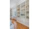 Spacious living room with hardwood floors, built-in shelves, and bright window with plantation shutters at 1 King St # 209 & 210, Charleston, SC 29401