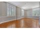 Bright living room featuring hardwood floors and plenty of natural light from large windows at 1 King St # 209 & 210, Charleston, SC 29401