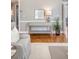 Living room featuring stylish console table with decor, warm lighting, and beautiful hardwood floors at 1 King St # 209 & 210, Charleston, SC 29401