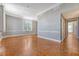 Well-lit living room showcasing hardwood floors, neutral walls, and large windows at 1 King St # 209 & 210, Charleston, SC 29401