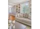 Cozy living room showcasing a comfortable couch, bright window, built-in shelves, and stylish decor at 1 King St # 209 & 210, Charleston, SC 29401