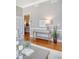 Living room featuring stylish console table with decor, warm lighting, and beautiful hardwood floors at 1 King St # 209 & 210, Charleston, SC 29401