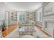 Spacious living area featuring built-in shelving, a fireplace, and large windows for ample natural light at 1 King St # 209 & 210, Charleston, SC 29401