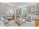 Inviting living room with hardwood floors, built-in shelves, and stylish decor at 1 King St # 209 & 210, Charleston, SC 29401