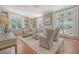 Cozy living room features large windows, custom built-ins, and a fireplace, ideal for relaxation at 1 King St # 209 & 210, Charleston, SC 29401