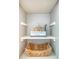 Bathroom storage cabinet with basket, books, and decorative sculpture at 1 King St # 209 & 210, Charleston, SC 29401