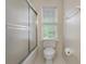 Bathroom featuring a white toilet, shower, and a window at 100 Dacs Ln, Summerville, SC 29483