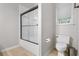 Bright bathroom featuring a shower with glass doors and a window at 100 Dacs Ln, Summerville, SC 29483