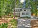 Exterior showcasing a manicured lawn, mature trees, and a charming two-story home at 100 Dacs Ln, Summerville, SC 29483