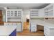 Bright kitchen featuring white cabinetry, a contrasting blue island, and wood floors at 100 Dacs Ln, Summerville, SC 29483