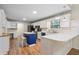 Well-lit kitchen with white cabinets, black appliances, and a blue island at 100 Dacs Ln, Summerville, SC 29483