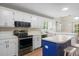 Modern kitchen featuring stainless steel appliances, a blue island, and white cabinets at 100 Dacs Ln, Summerville, SC 29483
